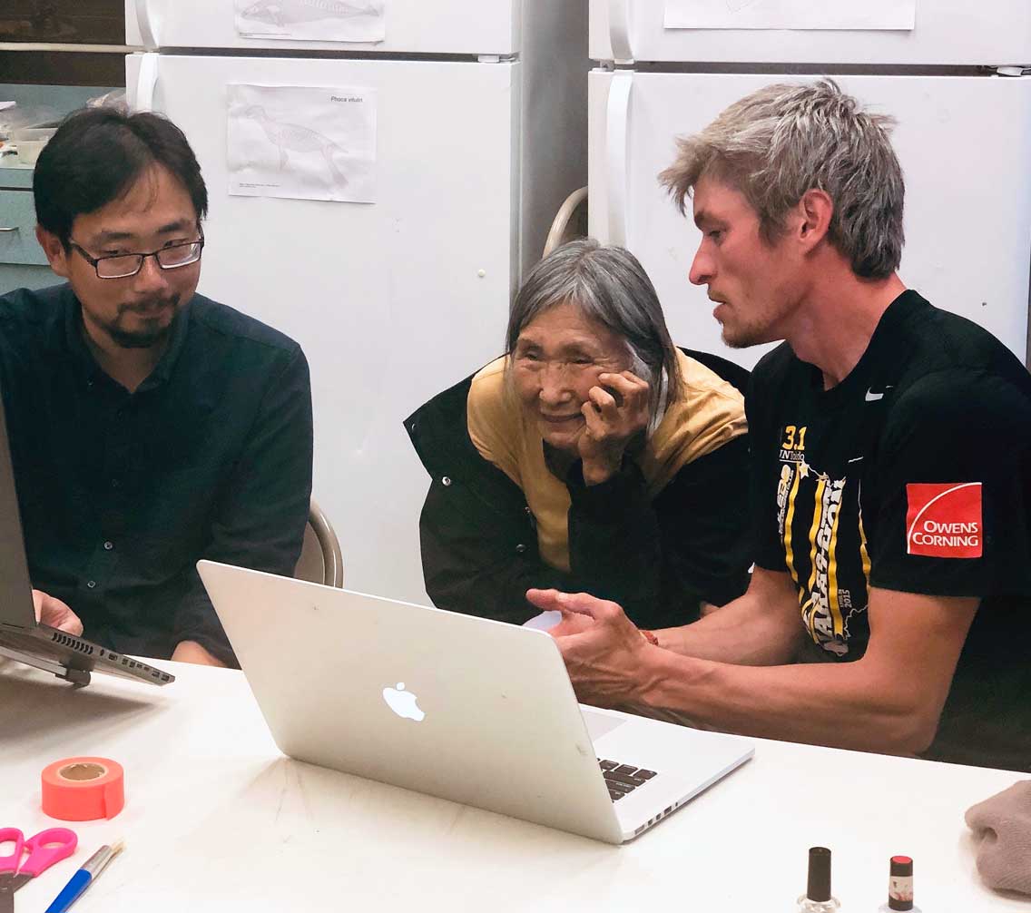 Dr. Sean Gleason working with Yupiit tribe member at a computer