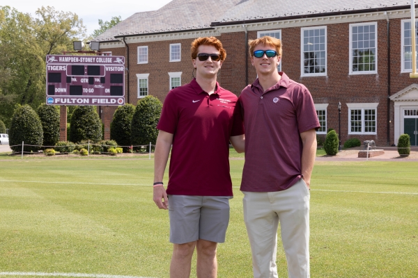 The Lasso brothers standing on the football field